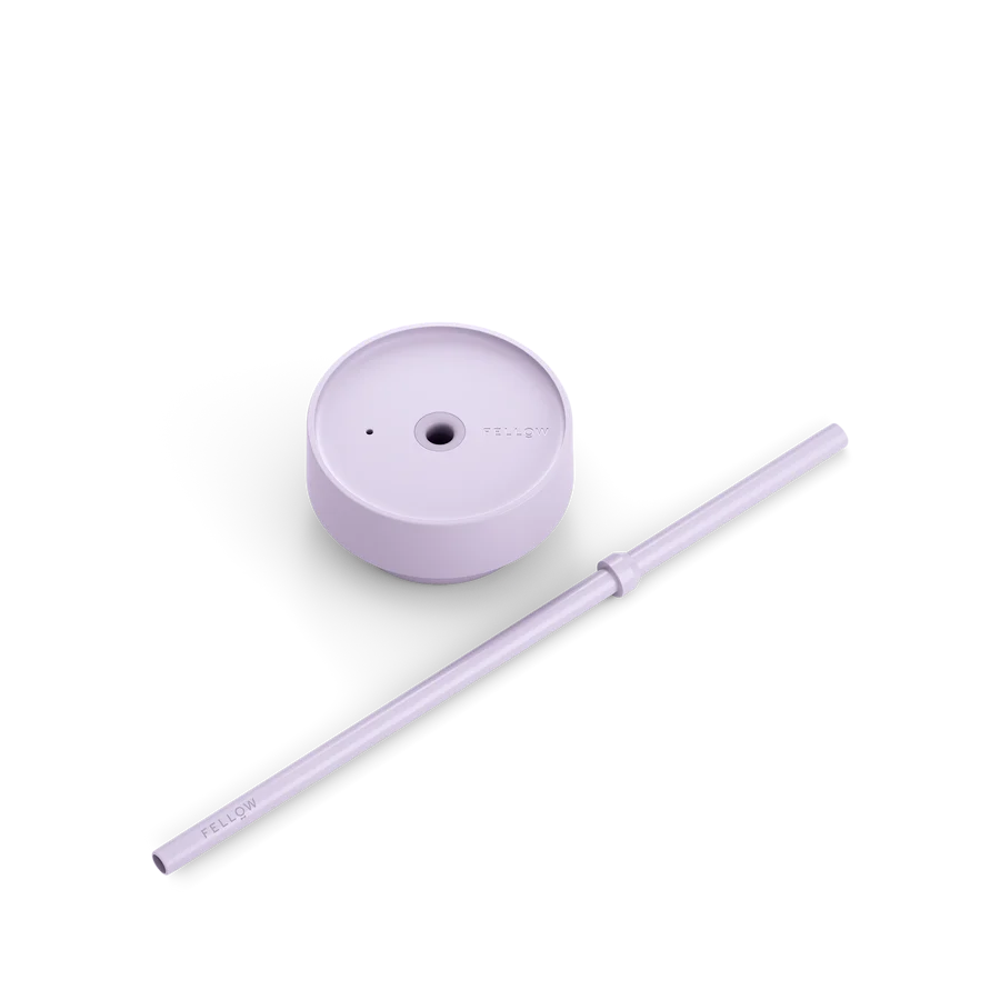 A light purple lid and straw for a travel mug. 